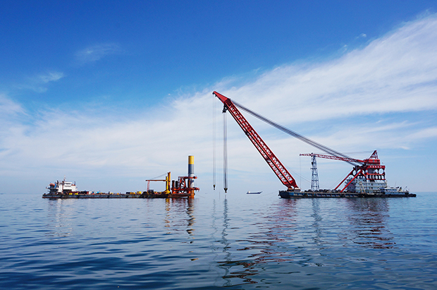 Four-legged frame positions mono piles at Liaoning Province Offshore Windfarm