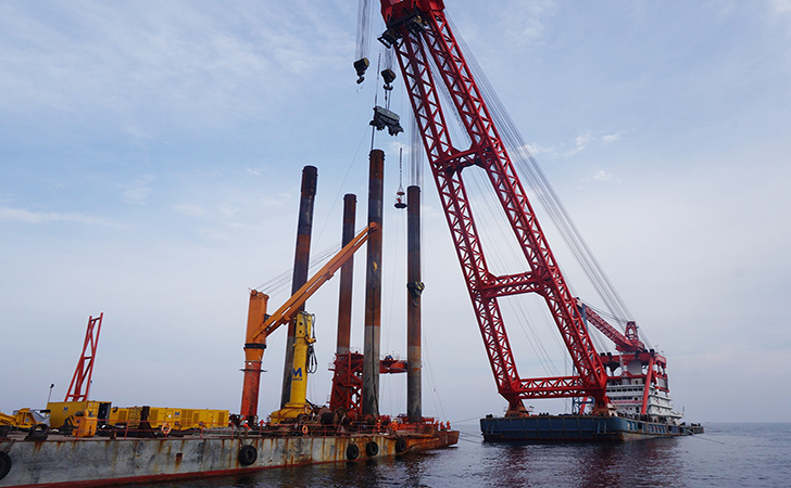 Four-legged frame positions mono piles at Liaoning Province Offshore Windfarm